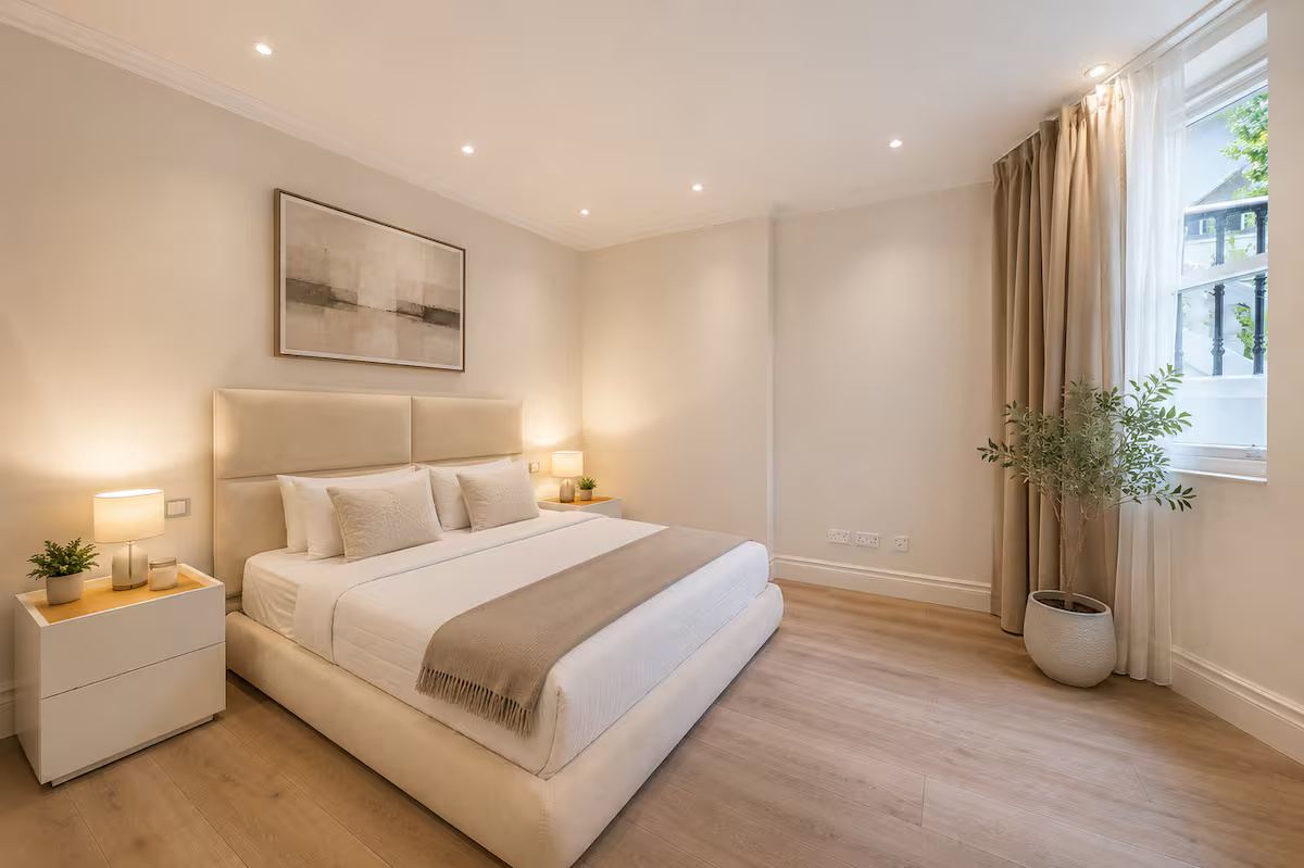 Bedroom with upholstered headboard and garden window