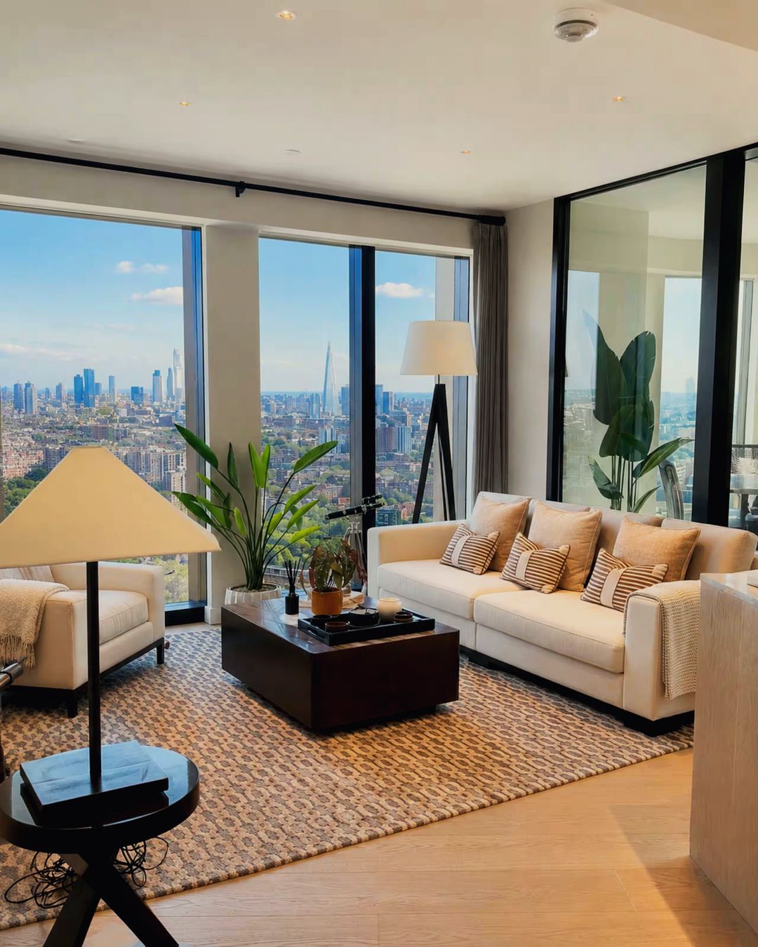 Living room with floor-to-ceiling glass and skyline view